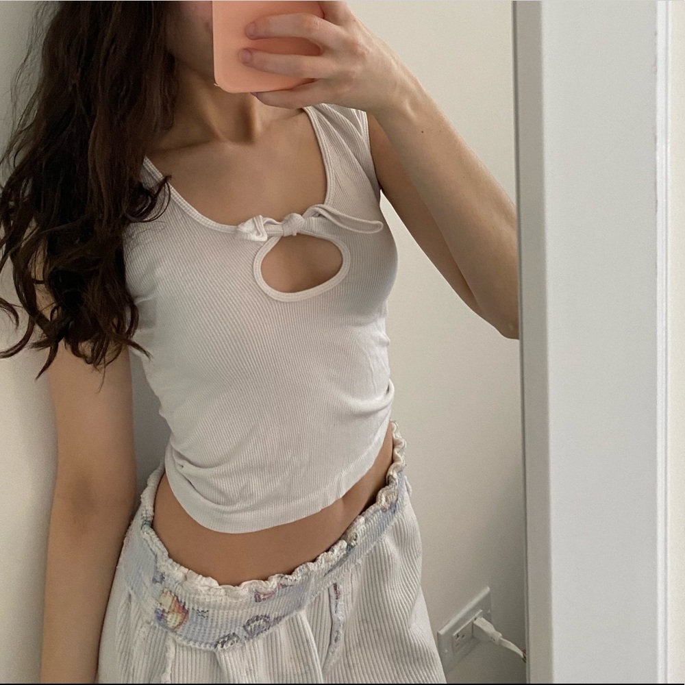 Suzette collection white ribbed shirt with keyhole and bow in the middle